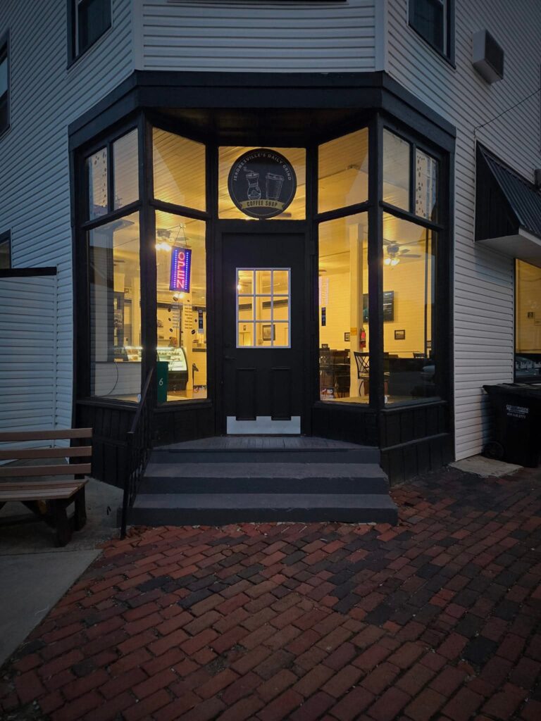 The Jeromesville Daily Grind storefront glowing at dusk